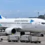 Ilustrasi pesawat Garuda Indonesia di kawasan bandara. Sepanjang Januari–September 2026, Garuda Indonesia Group mencatat pendapatan US$2,71 miliar, tetapi masih membukukan rugi periode berjalan sebesar US$179,3 juta.